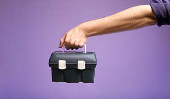 Eine Hand die einen mit Wasser gefüllten Messbecher hält. Symbolisch für die Fesstellung von Kompetenzen