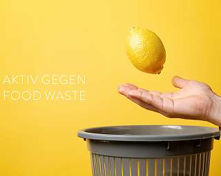 Eine Hand bewahrt eine Zitrone vor dem Entsorgen. Symbolisch für: Food Save